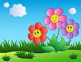 Three cartoon flowers on meadow