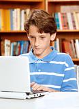 Boy Using Computer in Library