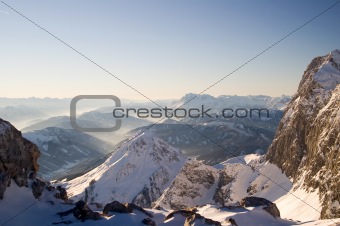 Alpine landscape of snow covered mountains and blue sky