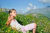 girl lying in a meadow backround Alps