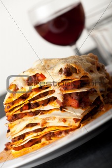 closeup of lasagna with red wine