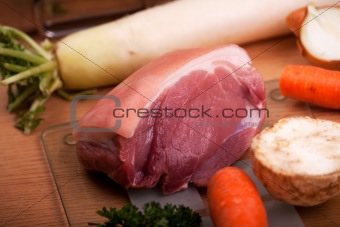 raw knuckle of pork on a chopping board