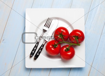 four tomatoes on a white plate