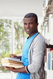 young african man smiling in library