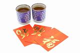 Chinese prosperity tea cups and red packets 