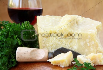 parmesan cheese on a wooden table with knife