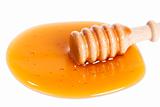 honey dipper in a puddle of honey