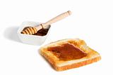toast with honey an a honey jar with a honey dipper