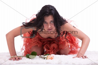 Beautiful woman on floor with a rose, on white, studio shot