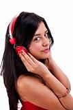 beautiful woman standing listening to music on red headphones, isolated on white, studio shot