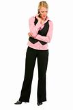 Full length portrait of smiling business woman talking on mobile phone
