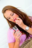 Sick woman taking pill and holding glass of water
