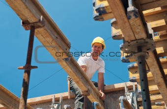 Construction worker placing formwork beams