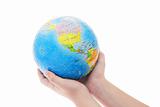 Hands holding globe jigsaw puzzle 