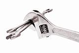 Adjustable wrench gripping a pair of spanners