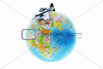 Miniature toy aircraft on globe