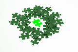 Isolated piece of green lumious jigsaw puzzle