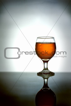 Glass of brandy with reflection