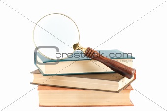 Magnifying glass and books