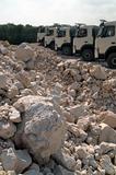 piles of gravel and trucks