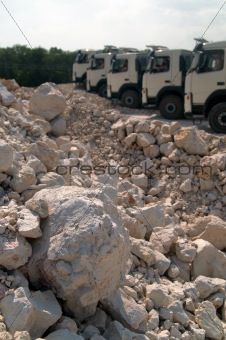 piles of gravel and trucks