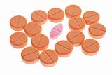 Red pill among orange favored lozenges