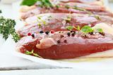 raw meat, duck fillet with spices and herbs