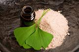 fresh leaves ginko biloba essential oil and powder - beauty treatment
