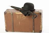 Old suitcase, bowler hat and umbrella