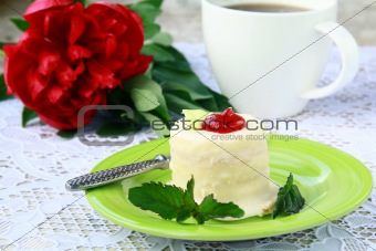 small cake on a plate with a cup of coffee elegant still life