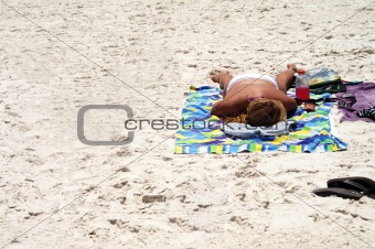 Lone sunbather Laying on Sandy Beach