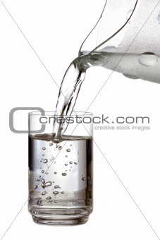 Filling a glass with water on white background