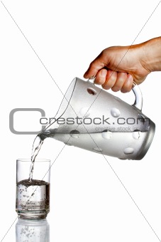 Hand pouring water from glass jug