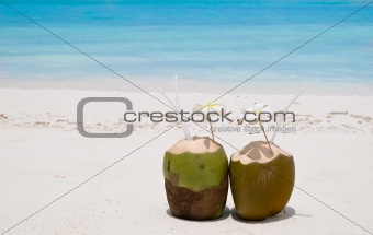 Tropical Coconut Cocktail in front of crystal blue ocean
