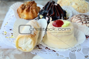 several kinds of cakes on a special stand dessert plates