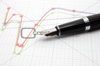 fountain pen on business chart