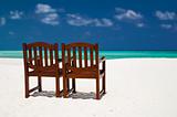 pair of chairs on a tropical beach
