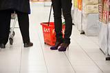 Shoppers Legs in Supermarket