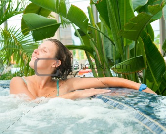Attractive young woamn relaxing in a Jacuzzi