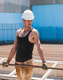 Construction worker carrying reinforcement steel bars