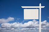 Blank White Real Estate Sign Over Clouds and Sky Ready For Your Own Message.