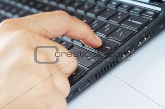 Finger pressing enter button on keyboard