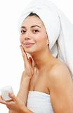 Beautiful women applying moisturizer cosmetic cream on face.