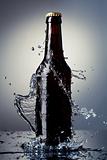 Beer bottle with water splash