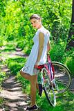 Young woman with a vintage bicycle