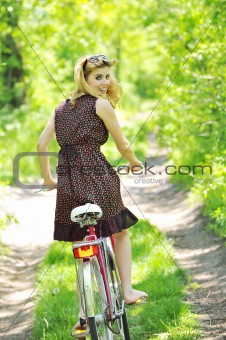 Young girl with a vintage bicycle