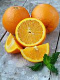 cut into slices and whole oranges with mint leaf