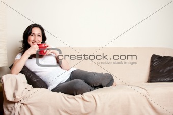 Woman with drink on couch