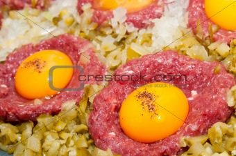 tartar steak with egg onion and pickle