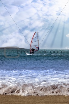 windsurfer in a storm with rays of sunshine